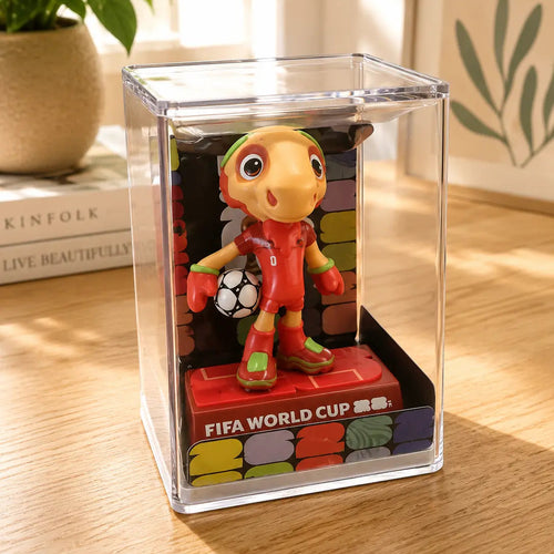 Colorful figurine of a soccer player in a clear display case on a wooden surface.